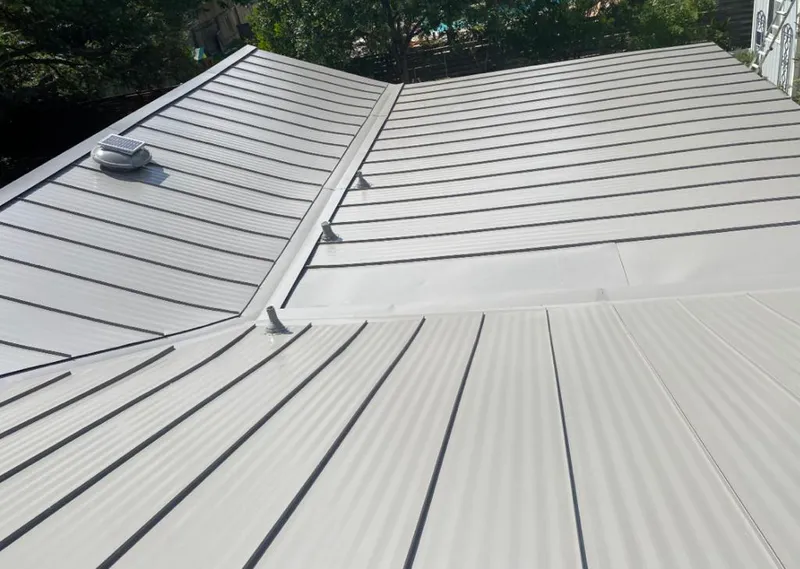 Solar attic fan installed on a metal roof for Roof Ventilation in Austintown
